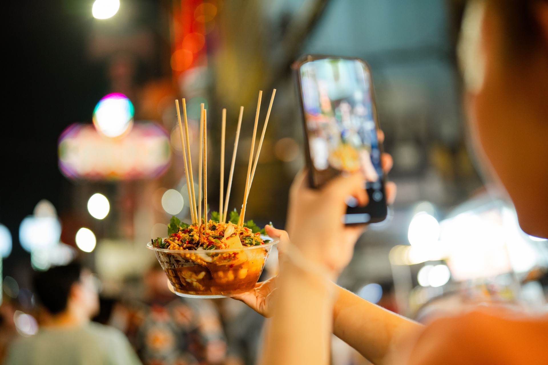 Vendors sell food in Chinatown in Bangkok.